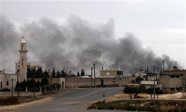 Smoke rises from burnt factories after being shelled at Khan al-Assal